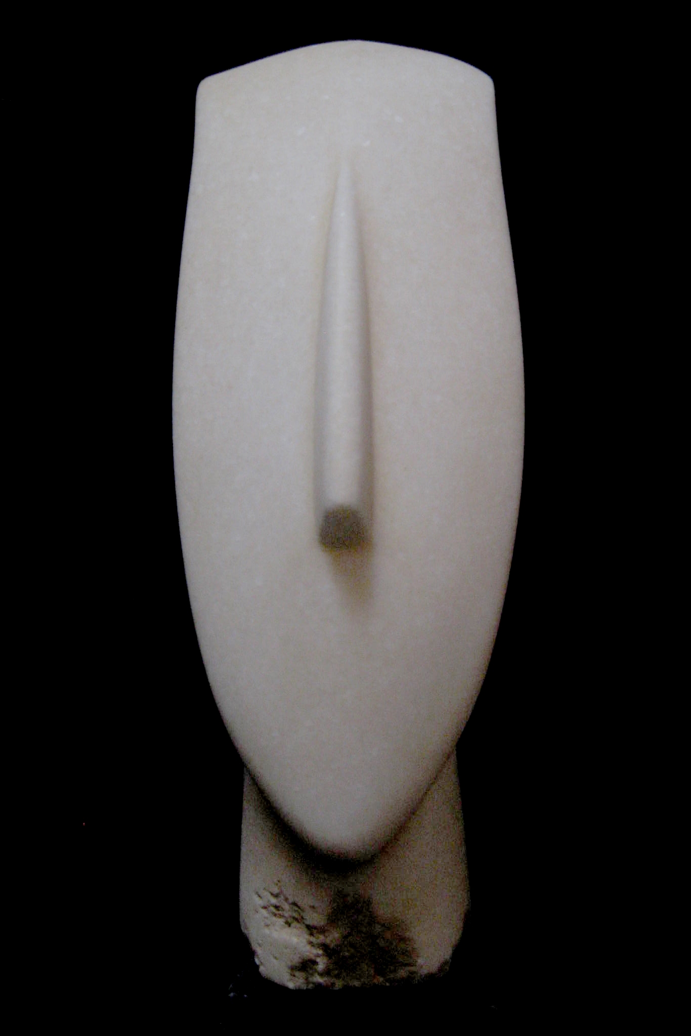 Cycladic head from the Aegean (dated 3300 - 2000 BC), its mute face raised to the sky